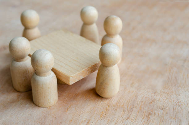 Close up of wooden figure having meeting or discussion. Meeting or discussion concept.